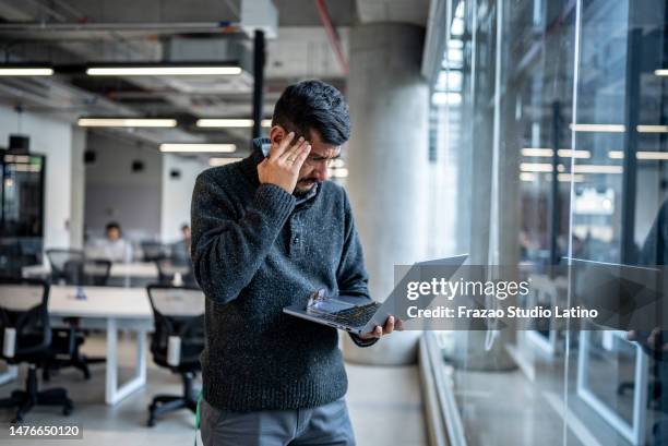 worried mature man using laptop working at office - tech founder stock pictures, royalty-free photos & images