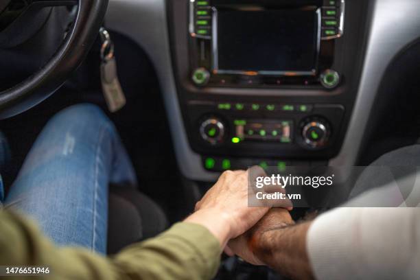 couple hands holding gearbox in car - holding hands in car stock pictures, royalty-free photos & images