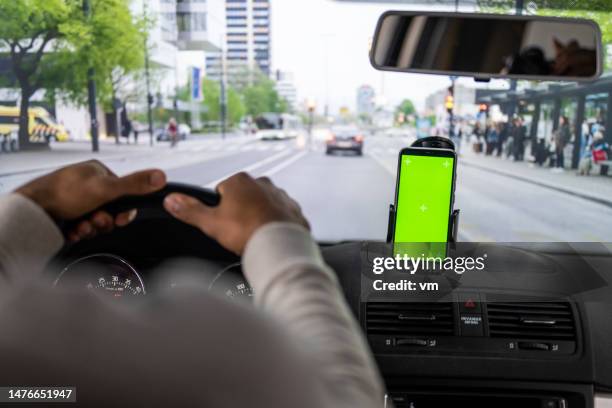 man driving car with smartphone attached to window - car point of view stock pictures, royalty-free photos & images