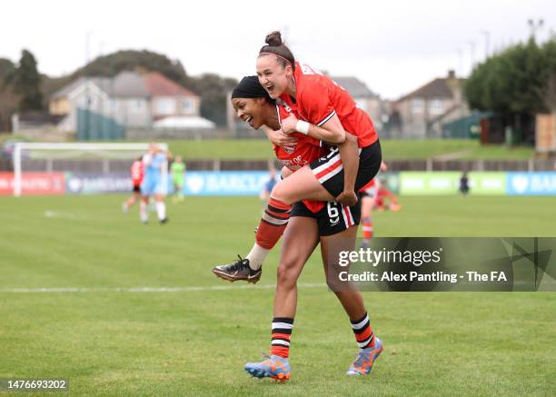 Melissa Johnson of Charlton Athletic celebrates with teammate Lois Roche after scoring the team's second goal during the Barclays FA Women's...