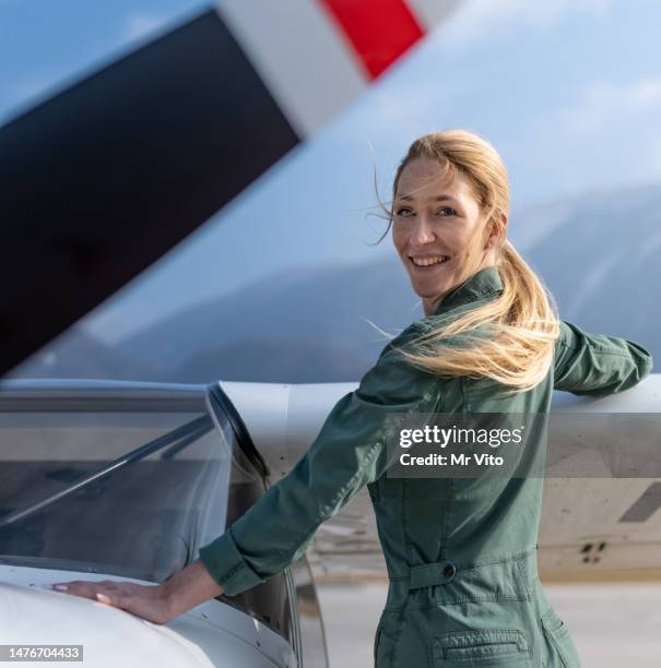 a female pilot with her sport plane - aviator glasses stock pictures, royalty-free photos & images