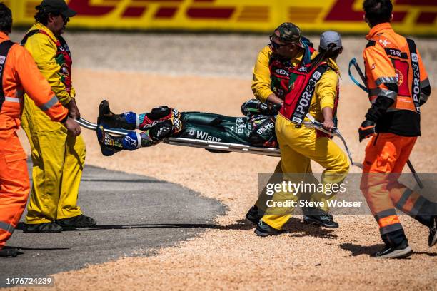Marshals carry Miguel Oliveira of Portugal and CryptoDATA RNF MotoGP Team across the gravel bed on a stretcher during the race of the MotoGP Grande...