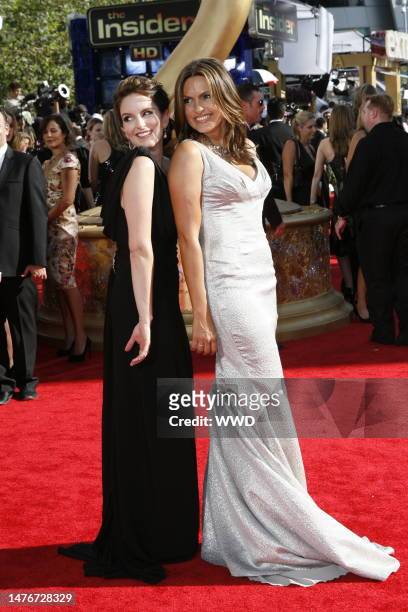 Tina Fey and Mariska Hargitay attend the 61st Primetime Emmy Awards at the NOKIA Theatre. Fey wears a Gucci gown, with a VBH clutch and art deco...