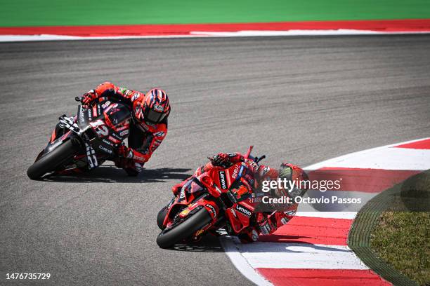 Francesco Bagnaia of Italy competes with their Ducati Lenovo Team and Maverick Vinales of Spain competes with their Aprilia Racing Team during the...