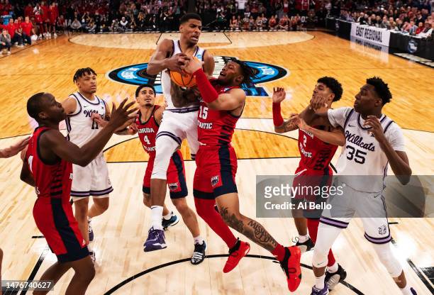 David N'Guessan of the Kansas State Wildcats and Alijah Martin of the Florida Atlantic Owls battle for the ball during their the Elite Eight round...