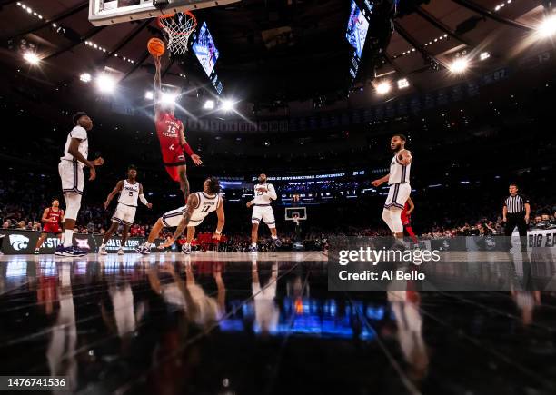 Alijah Martin of the Florida Atlantic Owls shoots the ball as Keyontae Johnson of the Kansas State Wildcats falls to the court during the first half...