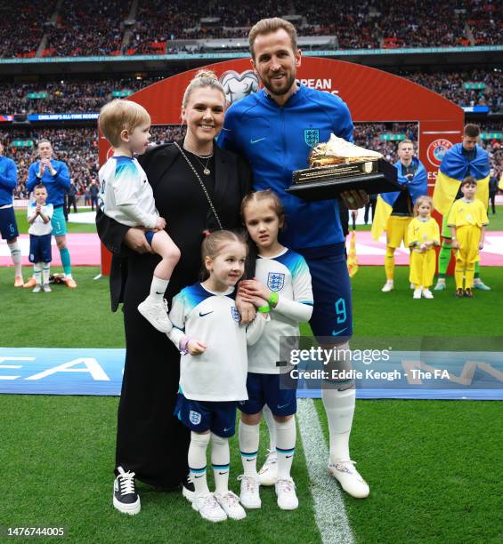 Harry Kane of England poses with their Golden Boot trophy alongside their Wife, Katie Goodland and Children, Ivy Jane Kane, Vivienne Jane Kane and...