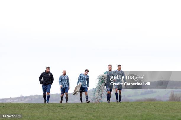 The players walk back with the goal net after the Chesterfield and District Sunday Football League HKL Division Two match between Hepthorne Lane and...