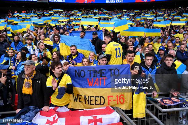 Fans of Ukraine hold up banners to show their support prior to the UEFA EURO 2024 qualifying round group C match between England and Ukraine at...