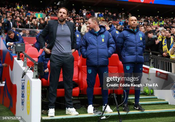 Gareth Southgate, Head Coach of England, Steve Holland, Assistant Coach of England and Paul Nevin, Coach of England look on prior to the UEFA EURO...