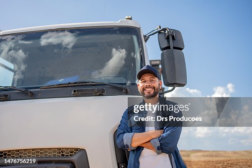 Portrait of truck driver in front of his truck Portrait of truck driver in front of his truck