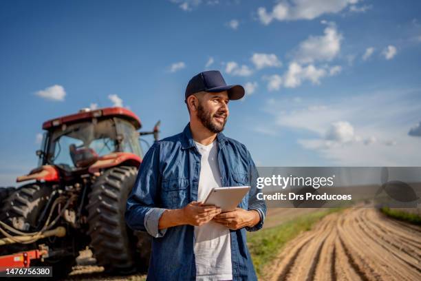retrato do agricultor com tablet na frente de seu trator - culturas - fotografias e filmes do acervo