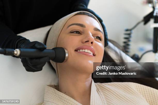 professional female cosmetologist doing hydradermabrasian procedure in cosmetology clinic. stock photo - electrolysis stock pictures, royalty-free photos & images