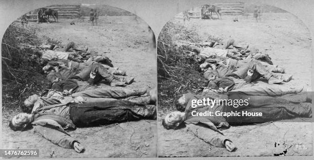 Stereoscopic image showing Confederate soldiers laid out in a row ahead of burial, killed during the Battle of Spotsylvania Court House, during the...