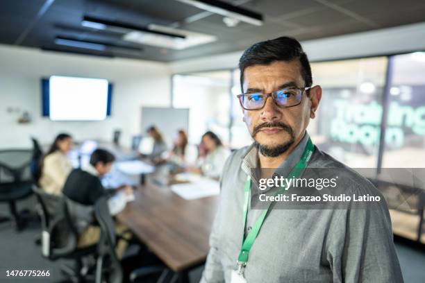 portrait of a mature leader businessman in the meeting room - employee badge stock pictures, royalty-free photos & images