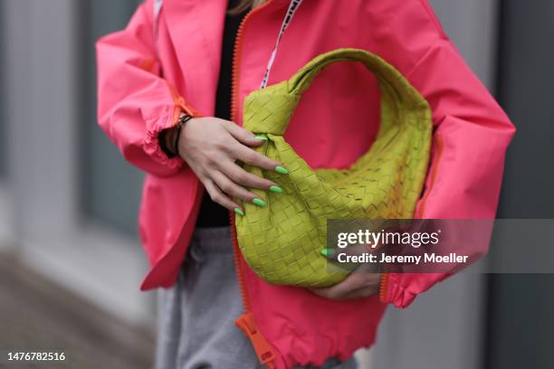 Sonia Lyson wearing Bottega Veneta neon green Teen Jodie bag, Krisjoy neon pink puffer winter cropped jacket, Frankie Shop grey joggingpants on March...