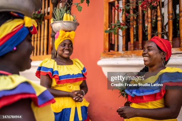 palenqueras talking on the street in cartagena, colombia - traditional colombian clothing stock pictures, royalty-free photos & images
