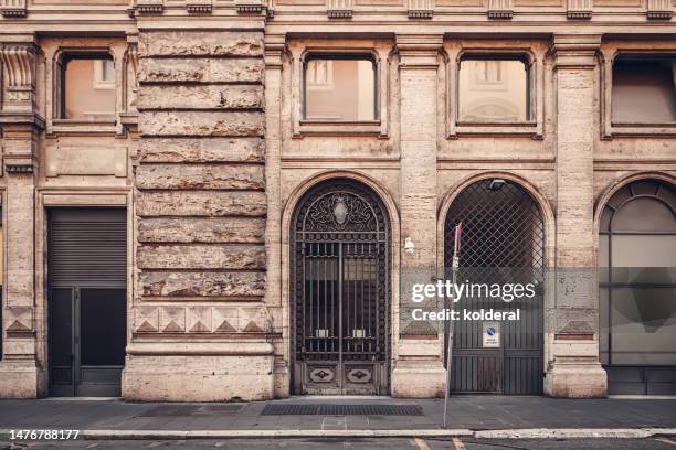 classic old building with architectural elements and forged doors. rome, italy - apartment front door foto e immagini stock