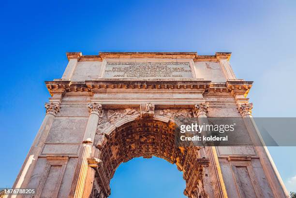 arch of titus low angle view against blue sky. rome, italy - arch of titus stock pictures, royalty-free photos & images