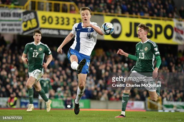 Robert Ivanov of Finland clears the ball whilst under pressure from Isaac Price of Northern Ireland during the UEFA EURO 2024 qualifying round group...