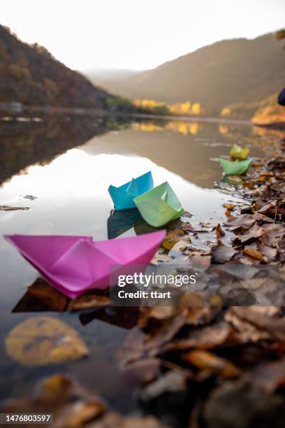 colorful paper boats, beautiful autumn colors of  lake reflection in boraboy lake and like wallpaper - toy boat stock pictures, royalty-free photos & images