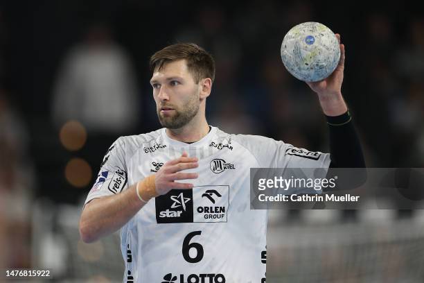 Harald Reinkind of THW Kiel controls the ball during the LIQUI MOLY HBL match between THW Kiel and Füchse Berlin at Wunderino Arena on March 26, 2023...
