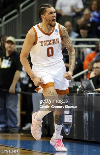 Timmy Allen of the Texas Longhorns celebrates during the first half against the Miami Hurricanes in the Elite Eight round of the NCAA Men's...