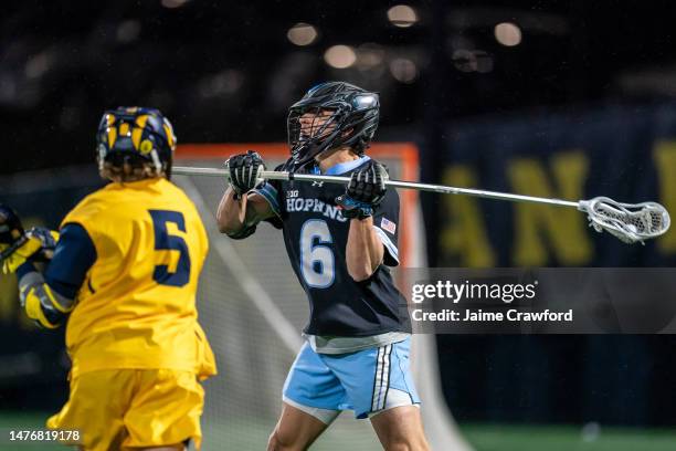 Alex Mazzone of the Johns Hopkins Blue Jays looks for a pass against pressure from Michael Boehm of the Michigan Wolverines during the 3rd quarter at...