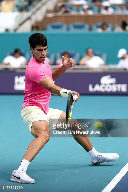 Carlos Alcaraz of Spain returns a serve to Dusan Lajovic of Serbia during the Miami Open at Hard Rock Stadium on March 26, 2023 in Miami Gardens,...