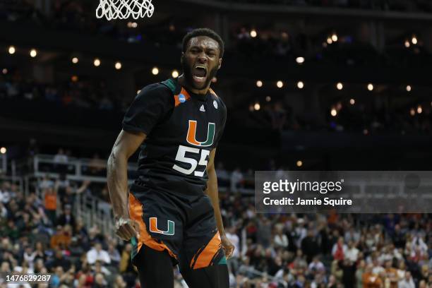 Wooga Poplar of the Miami Hurricanes reacts after dunking the ball during the second half against the Texas Longhorns in the Elite Eight round of the...