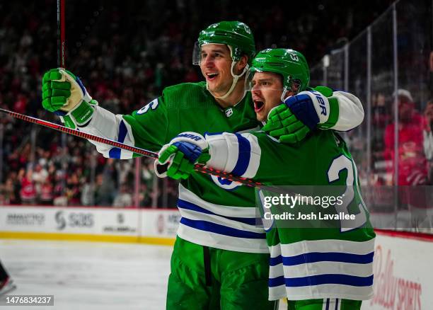 Sebastian Aho of the Carolina Hurricanes celebrates with Brady Skjei after a goal during the third period against the Boston Bruins at PNC Arena on...