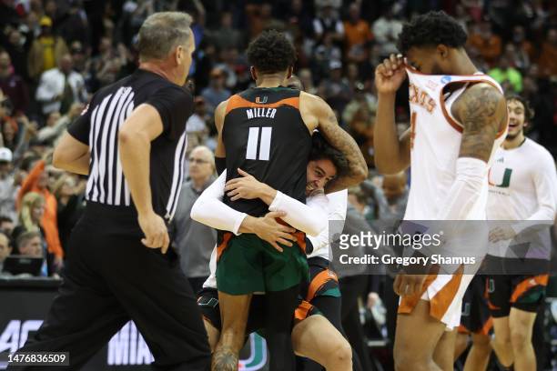 Jordan Miller of the Miami Hurricanes celebrates with teammates after defeating the Texas Longhorns 88-81 in the Elite Eight round of the NCAA Men's...
