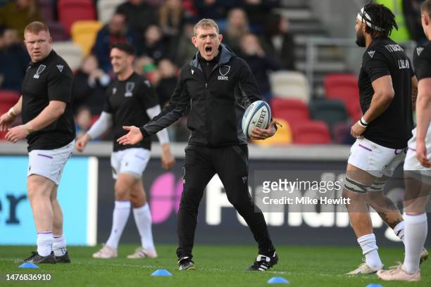 Northampton coach Sam Vesty takes part in the warm up ahead of the Gallagher Premiership Rugby match between London Irish and Northampton Saints at...