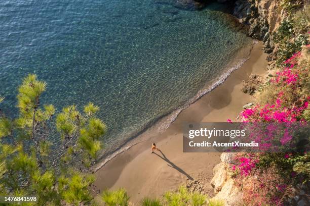 woman on a stunning beach in agia pelagia, crete - crete woman stock pictures, royalty-free photos & images