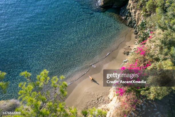 woman on a stunning beach in agia pelagia, crete - herakleion stockfoto's en -beelden