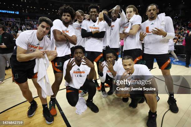 Miami Hurricanes players pose after defeating the Texas Longhorns 88-81 in the Elite Eight round of the NCAA Men's Basketball Tournament at T-Mobile...