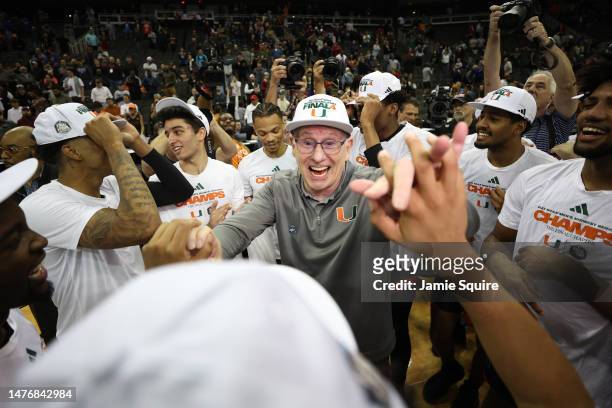 Head coach Jim Larrañaga of the Miami Hurricanes celebrates with players after defeating the Texas Longhorns 88-81 in the Elite Eight round of the...