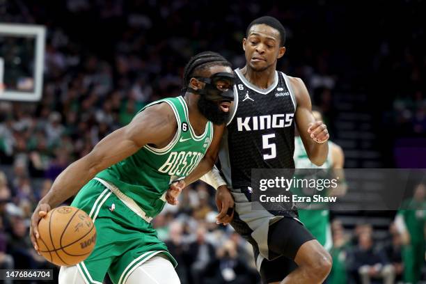 Jaylen Brown of the Boston Celtics is guarded by De'Aaron Fox of the Sacramento Kings at Golden 1 Center on March 21, 2023 in Sacramento, California....