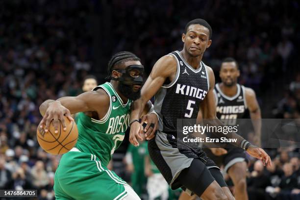 Jaylen Brown of the Boston Celtics is guarded by De'Aaron Fox of the Sacramento Kings at Golden 1 Center on March 21, 2023 in Sacramento, California....