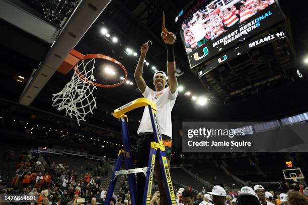 Jordan Miller of the Miami Hurricanes cuts the net after defeating the Texas Longhorns 88-81 in the Elite Eight round of the NCAA Men's Basketball...