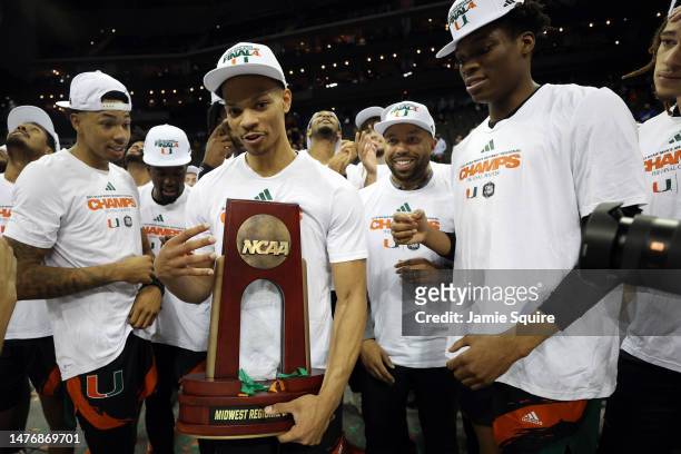 Isaiah Wong of the Miami Hurricanes celebrates with teammates and the trophy after defeating the Texas Longhorns 88-81 in the Elite Eight round of...