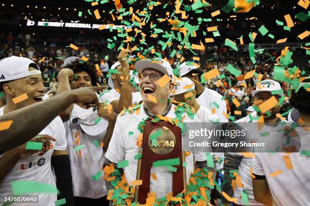 Head coach Jim Larrañaga of the Miami Hurricanes celebrates with players after defeating the Texas Longhorns 88-81 in the Elite Eight round of the...