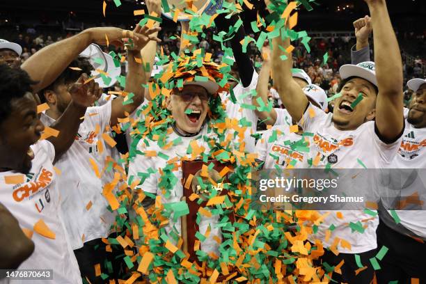 Head coach Jim Larrañaga of the Miami Hurricanes celebrates with players after defeating the Texas Longhorns 88-81 in the Elite Eight round of the...