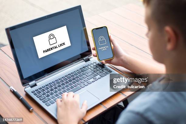 teenage boy holding phone with lock screen. parental lock concept. - ouderlijke controle stockfoto's en -beelden