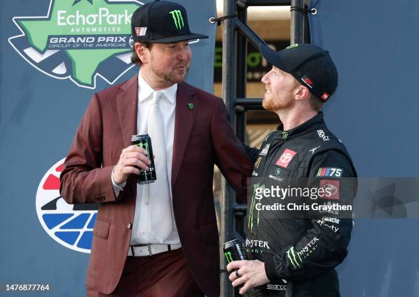 Retired NASCAR driver and advisor to 23XI Racing, Kurt Busch congratulates Tyler Reddick, driver of the Monster Energy Toyota in victory lane after...