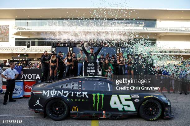 Tyler Reddick, driver of the Monster Energy Toyota, celebrates in victory lane after winning the NASCAR Cup Series EchoPark Automotive Grand Prix at...