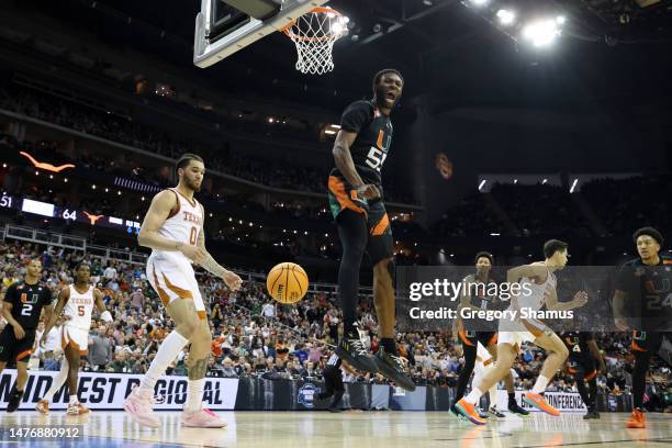 Wooga Poplar of the Miami Hurricanes reacts as he dunks the ball during the second half against the Texas Longhorns in the Elite Eight round of the...