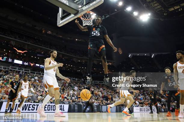 Wooga Poplar of the Miami Hurricanes reacts as he dunks the ball during the second half against the Texas Longhorns in the Elite Eight round of the...