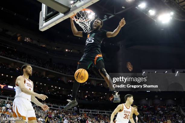 Wooga Poplar of the Miami Hurricanes reacts as he dunks the ball during the second half against the Texas Longhorns in the Elite Eight round of the...