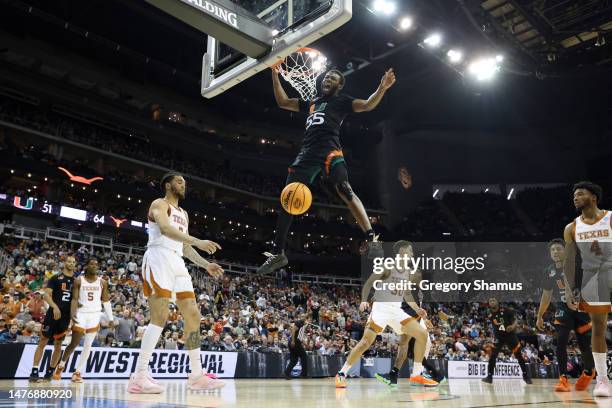 Wooga Poplar of the Miami Hurricanes reacts as he dunks the ball during the second half against the Texas Longhorns in the Elite Eight round of the...